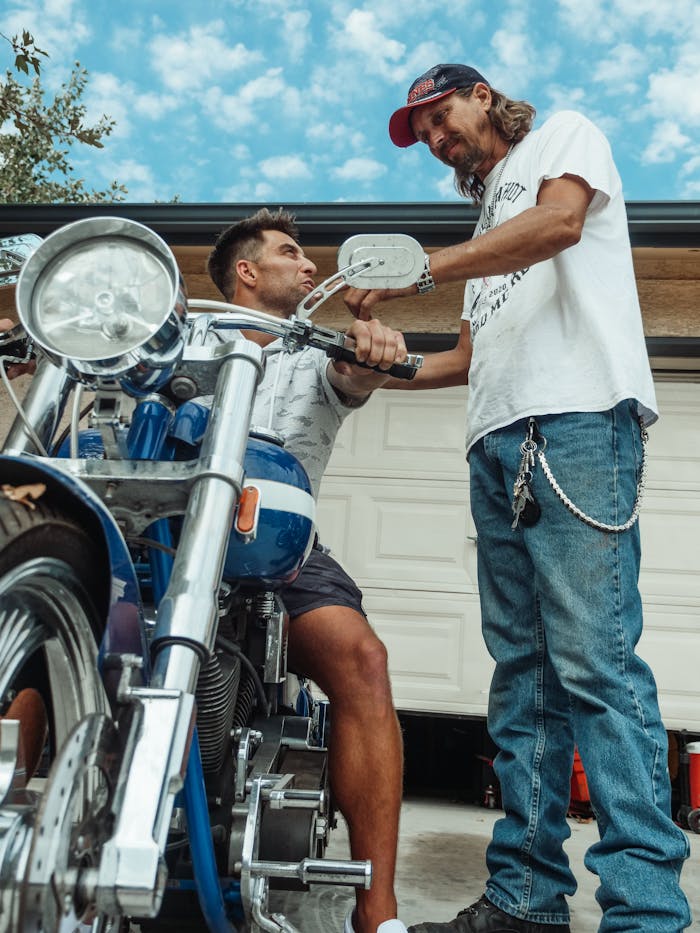 About Father and son in garage working on motorcycle, sharing a bonding moment.